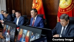 Kyrgyz President Sadyr Japarov (center) called for "patience and peace," claiming that "manipulative" information is being posted online to "disrupt friendly ties with Kyrgyzstan's neighbors."