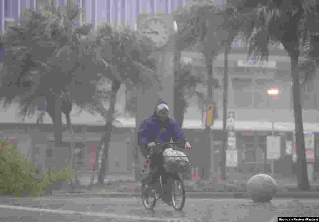 Čovjek na biciklu pod jakom kišom i vjetrom uzrokovanom tajfunom Nanmadol u Miyazakiju na najjužnijem glavnom japanskom ostrvu Kjušu 18. septembra 2022.