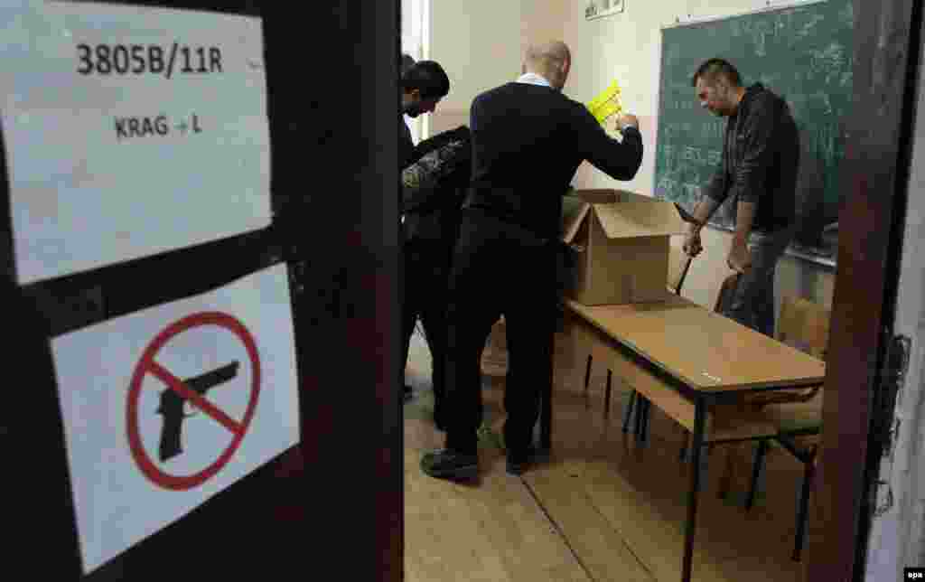 Election-committee members prepare for voting at a polling station in Mitrovica, which is divided ethnically between north and south.