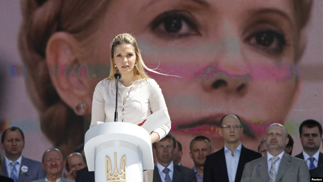 Yevhenia Tymoshenko, daughter of Yulia Tymoshenko, addresses supporters of opposition parties in front of a screen displaying a picture of her jailed mother at a May 12 rally in Kyiv.