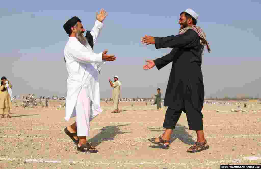 People greet each other after offering Eid al-Adha prayers in Jalalabad, Afghanistan. Eid al-Adha is the holiest of the two Muslims holidays celebrated each year. (epa/Ghulamullah Habibi)