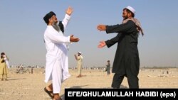 People greet each other after offering Eid al-Adha prayers in Jalalabad, Afghanistan, on September 1.