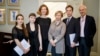 Composer Anthony Bolton (right); Olivia Ray (third from left), who plays the role of Anna Politkovskaya; Marina Litvinenko (third from right), Aleksandr Litvinenko's widow; and musicians pose for a photo during the press launch of the opera in London on February 24.