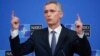 NATO Secretary-General Jens Stoltenberg talks to reporters ahead of a defense ministers meeting at NATO headquarters in Brussels on February 12.