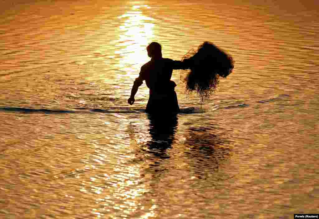 An Afghan man tries to catch fish during sunset by a river on the outskirts of Jalalabad on October 3. (Reuters/Parwiz)