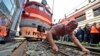 Athlete and powerlifter Ivan Savkin pulls a train with several carriages, weighing a combined 120 tons, in the Russian Far East city of Vladivostok. (Reuters/Yuri Maltsev)