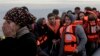Refugees and migrants arrive by dinghy from Turkey on the Greek island of Lesbos in February. Despite Ankara's crackdown on such transports, people smugglers are confident that it won't have too much of an adverse impact on their trade. 