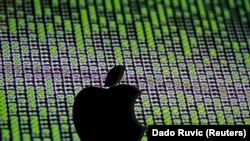 A 3D printed Apple logo is seen in front of a displayed cyber code - generic