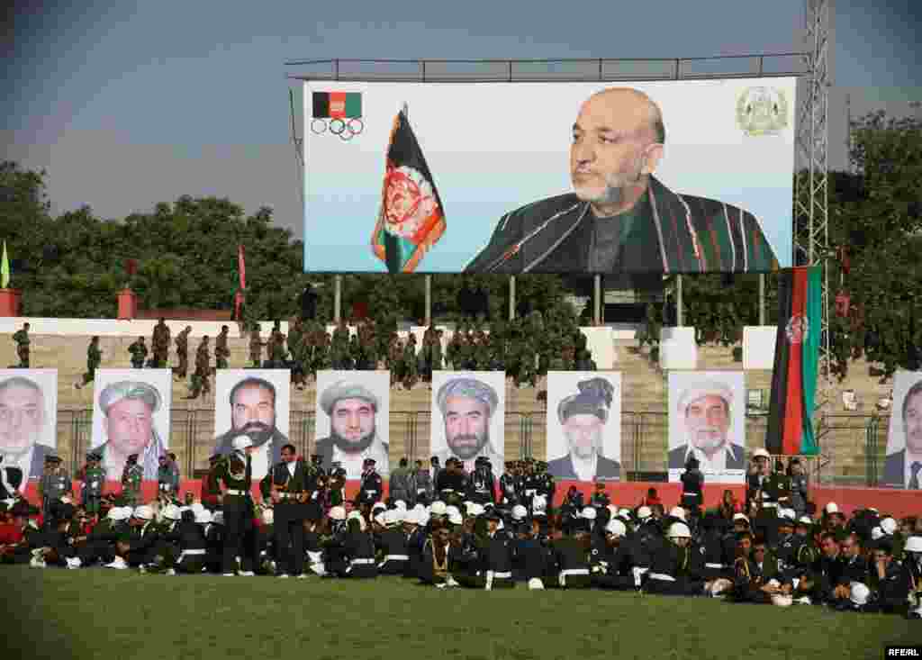 Afghan officers and military academy cadets sit in front of large portraits of President Hamid Karzai and commanders who were killed during the Soviet invasion in the 1980s. Photo by RFE/RL