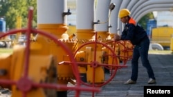 A worker turns a valve at an underground gas storage facility near Stryi, Ukraine.