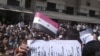 تظاهرکننده ای در شهر بانیاس سوریه پوستری در دست دارد که در واکنش به اتهام های دولت دمشق، در آن نوشته شده است: «آیا همه شهرهای سوریه تروریست هستند!؟؟؟»