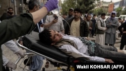 Medical staff move a wounded youth on a stretcher outside a hospital in Kabul in April after two bomb blasts rocked a boys' school in a Shi'ite Hazara neighborhood, killing at least six people.