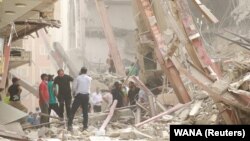 Rescue crews work at the site of a collapsed building in Abadan, Iran, on May 23.