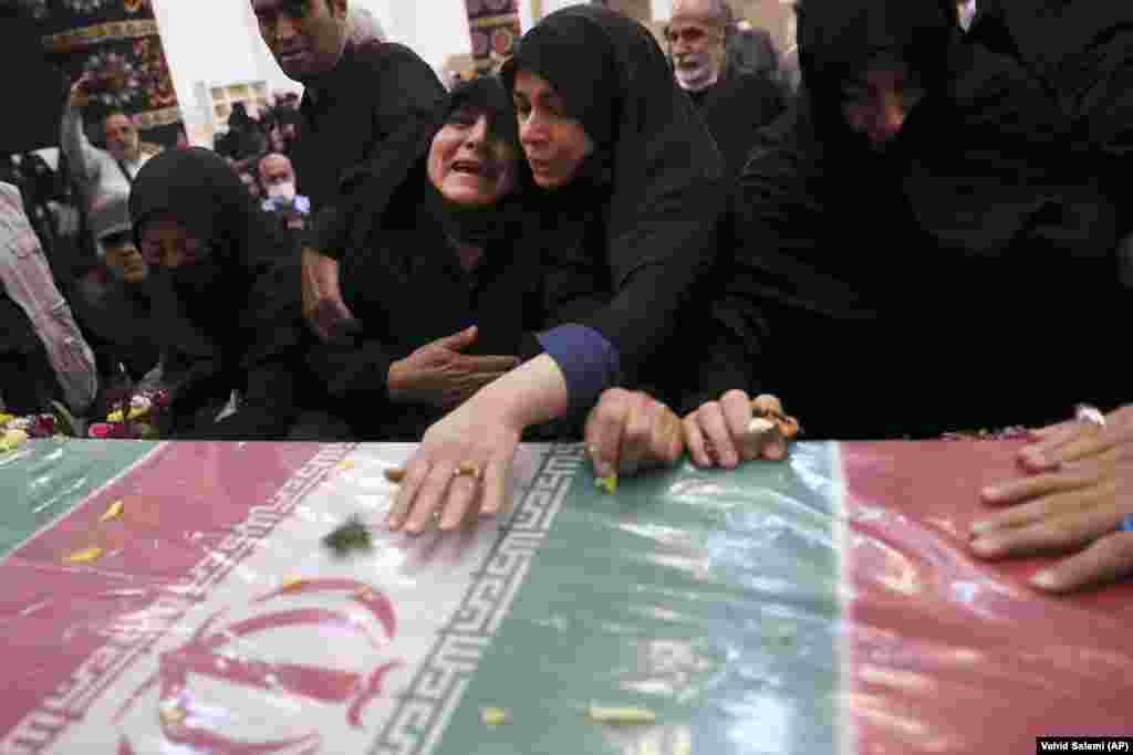 Relatives mourn over the flag-draped coffin of Colonel Hassan Sayad Khodaei in Tehran on May 24. Khodaei, an officer with Iran&#39;s powerful Islamic Revolutionary Guards Corps, had been assassinated two days previously.&nbsp;