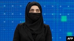 Thamina Usmani, a female presenter for Tolo News, covers her face in a live broadcast at the Tolo TV station in Kabul. (file photo)