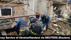 Rescuers remove people from rubble after an air strike in Bakhmut in Ukraine's Donetsk region. 