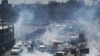 Police use tear gas to disperse activists of the Pakistan Tehrik-e Insaf party during a protest in Lahore on May 25.