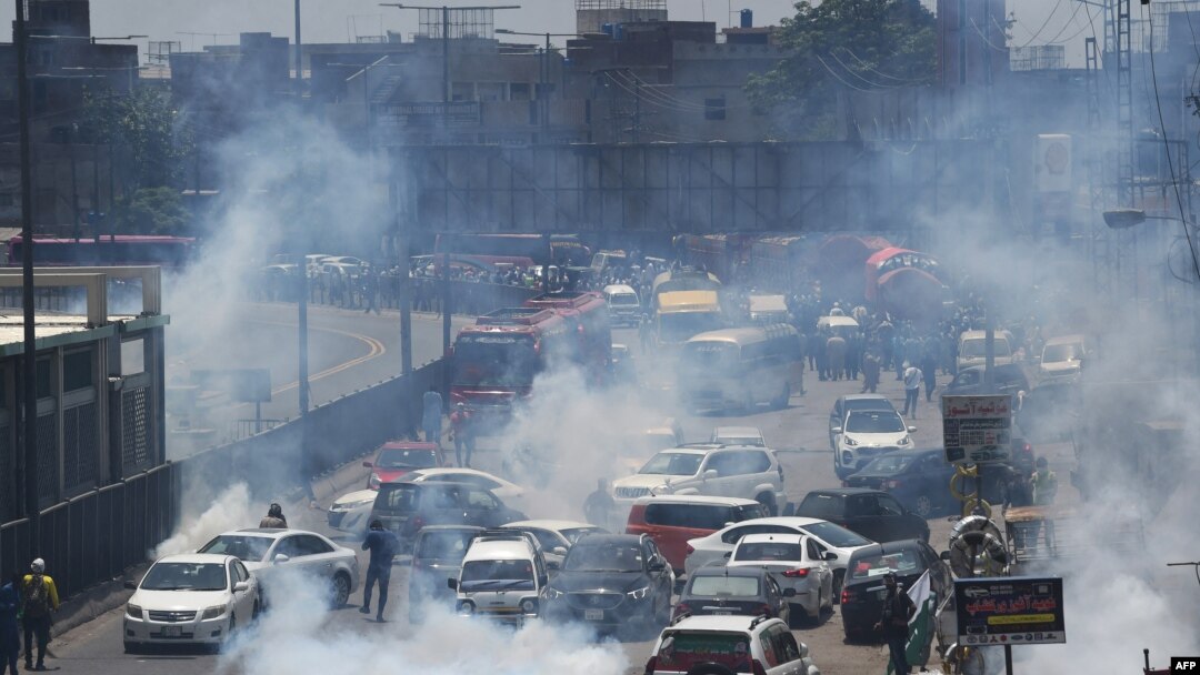 Police use tear gas to disperse activists of the Pakistan Tehrik-e Insaf party during a protest in Lahore on May 25.