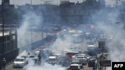 Police use tear gas to disperse activists of the Pakistan Tehrik-e Insaf party during a protest in Lahore on May 25.