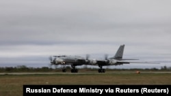 A Russian Tu-95 strategic bomber takes off during Russian-Chinese military exercises to patrol the Asia-Pacific region in May.