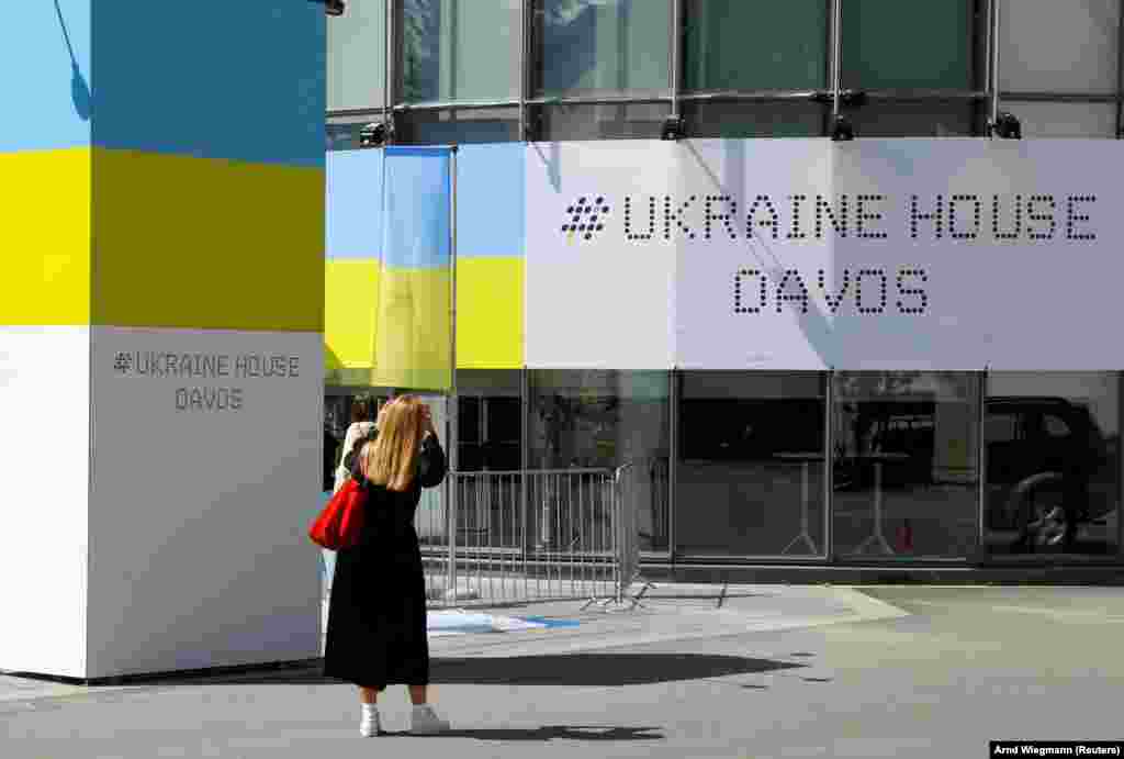 Egy nő fotózza a Davosban kialakított Ukrajna Házat május 21-én