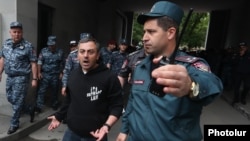 Armenia - Opposition leader Ishkhan Saghatelian argues with a senior police officer outside the Armenian Foreign Ministry, May 24, 2022.