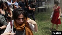 Stambul şäheriniň Taksim meýdanynda howpsuzlyk güýçleri protestçileriň garşysyna göz ýaşardyjy gazlary we ajy sepiji serişdeleri ulanýarlar. 28-nji maý, 2013 ý. 