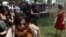 In a photo adopted by protesters as a symbol of their struggle, a Turkish policeman uses tear gas against a woman during a rally in Taksim Square in central Istanbul on May 28.