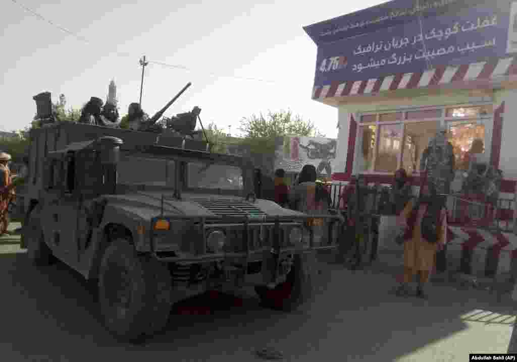 Taliban fighters stand guard at a checkpoint in Kunduz city in northern Afghanistan.&nbsp;On August 9, Taliban fighters overran Aybak, the capital of the northern Samangan Province as national security forces battled militants in three other northern provinces -- Balkh, Takhar, and Kunduz.&nbsp;The fall of Aybak came a day after militants overran three provincial capitals, including most of the strategic northeastern city of Kunduz, the provincial capital of Sar-e Pol, and Taloqan, the capital of northeastern Takhar Province.