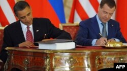 U.S. President Barack Obama (left) and his Russian counterpart, Dmitry Medvedev, sign the New START treaty in Prague on April 8, 2010.