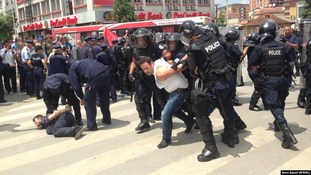 Riot police used pepper spray to disperse the crowd and tried to push it back to clear the entrance to parliament.