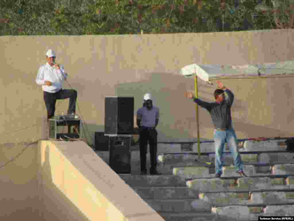 Supervisors and choreographers oversee the preparations for Independence Day celebrations from the stands of the Labor Stadium.