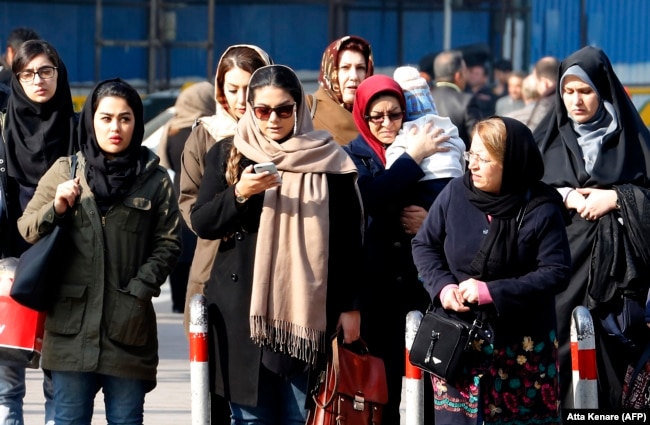 Iranian women wearing the compulsory hijab walk down a street in the capital, Tehran. (file photo)