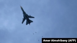 A Syrian air force MiG-23 jet drops a payload during a reported regime air strike in the rebel-held town of Arbin, in the besieged Eastern Ghouta region on the outskirts of the capital Damascus, February 7, 2018
