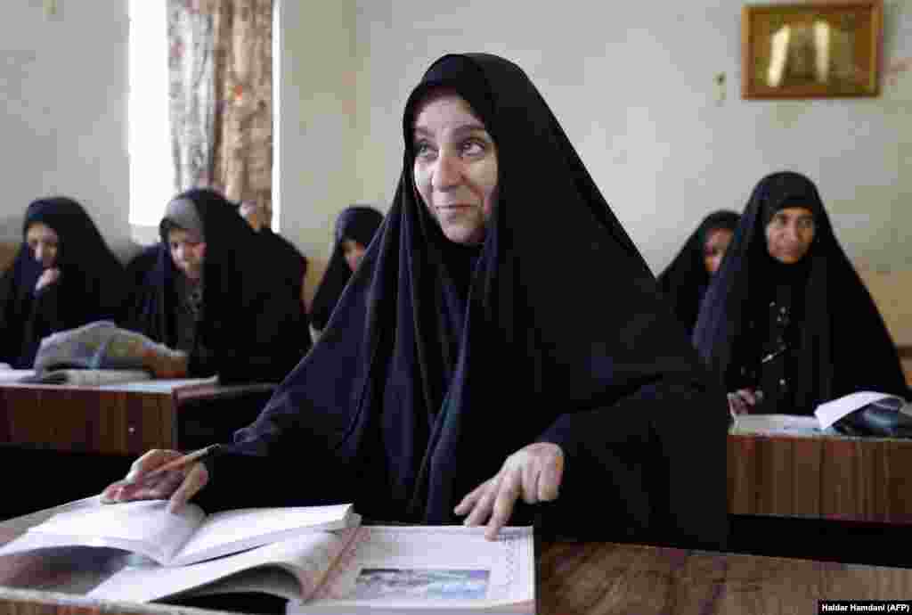 Iraqi women take part in a governmental literacy program for adults in the holy city of Najaf. (AFP/Haidar Hamdani)