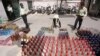 Iranian police prepare to destroy confiscated bottles of alcohol in Tehran.