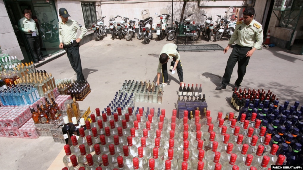 Iranian police prepare to destroy confiscated bottles of alcohol in Tehran.