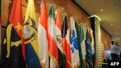 Algeria -- An Algerian security guard stands near the flags of member states of the Organization of the Petroleum Exporting Countries (OPEC) at the Sheraton hotel, Oran, 14Dec2008 