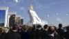 People attend the inauguration of a gilded equestrian statue of Turkmen President Gurbanguly Berdymukhammedov in Ashgabat in May 2015. 