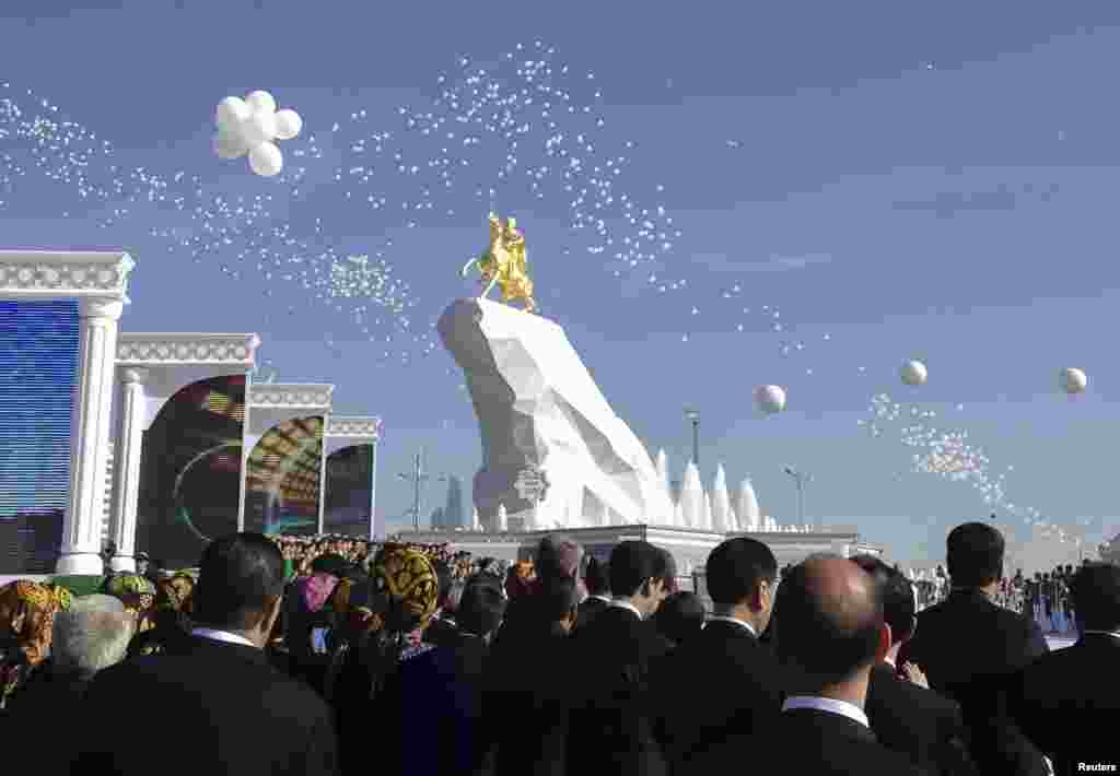 People gather in front of a monument to Turkmen President Gurbanguly Berdymukhammedov during its inauguration ceremony in Ashgabat on May 25. (Reuters/​Marat Gurt)&nbsp;