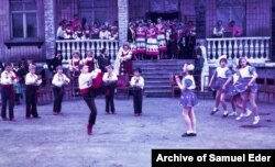 Children dancing in Opytne. Today less than 50 people remain and almost all of the buildings have been damaged or destroyed by the fighting.