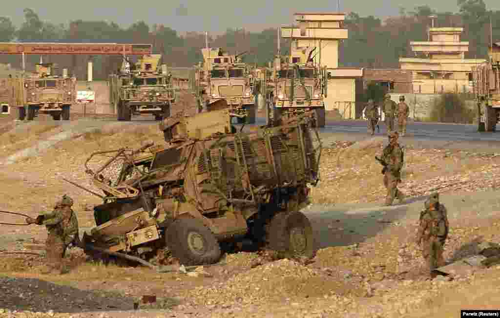 A NATO armored vehicle after being hit by a suicide bombing in Jalalabad in 2014. Today, after nearly two decades of fighting, Taliban envoys are negotiating separately in at least two sets of talks -- one with U.S. officials and the other with Russian encouragement -- toward a controversial and potentially complex peace deal that could see U.S. troops withdraw from Afghanistan.