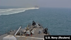 AT SEA -- The U.S. Navy guided-missile destroyer USS The Sullivans and the Military Sealift Command joint high-speed vessel USNS Choctaw County transit through the Strait of Hormuz, August 8, 2018