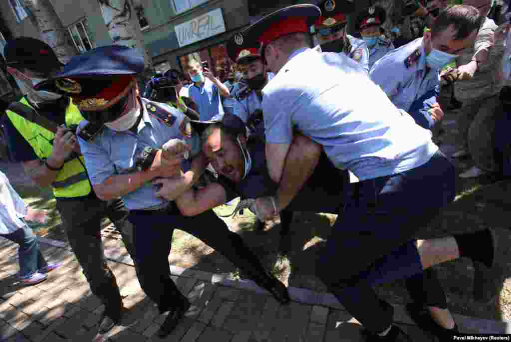 Kazakh police detain a man in Almaty.