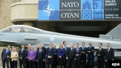 Leaders from NATO countries watch a fly-past by the RAF Red Arrows aerobatic team during the NATO summit.