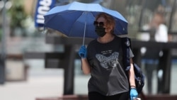 Armenia -- A woman in Yerevan wears a protective mask and gloves, June 10, 2020.