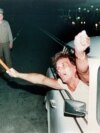 An East German waves a West German flag while crossing from Hungary into Austria early on September 11, 1989, the first day of eased travel restrictions to the West.&nbsp;