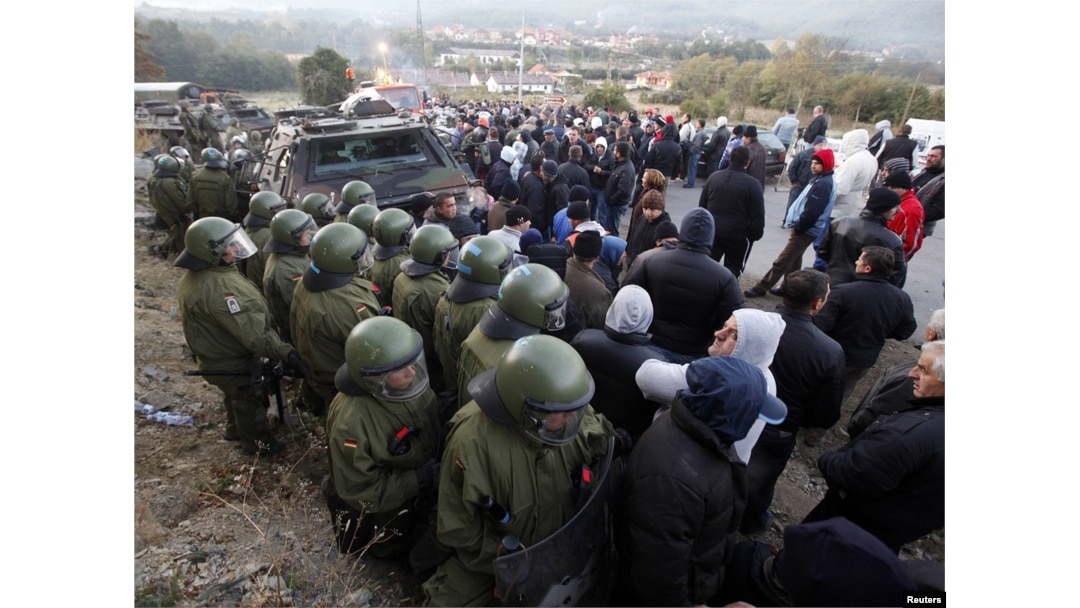 Protesting Kosovo Serbs stand on the street in front of NATO's Kosovo Force (KFOR) soldiers from Germany in the village of Jagnjenica near the town of Zubin Potok on October 20.