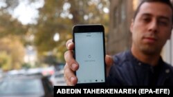 An Iranian man shows his phone while unable to load a social-media page in Tehran. Authorities block tens of thousands of websites and regularly throttle or cut Internet connectivity.