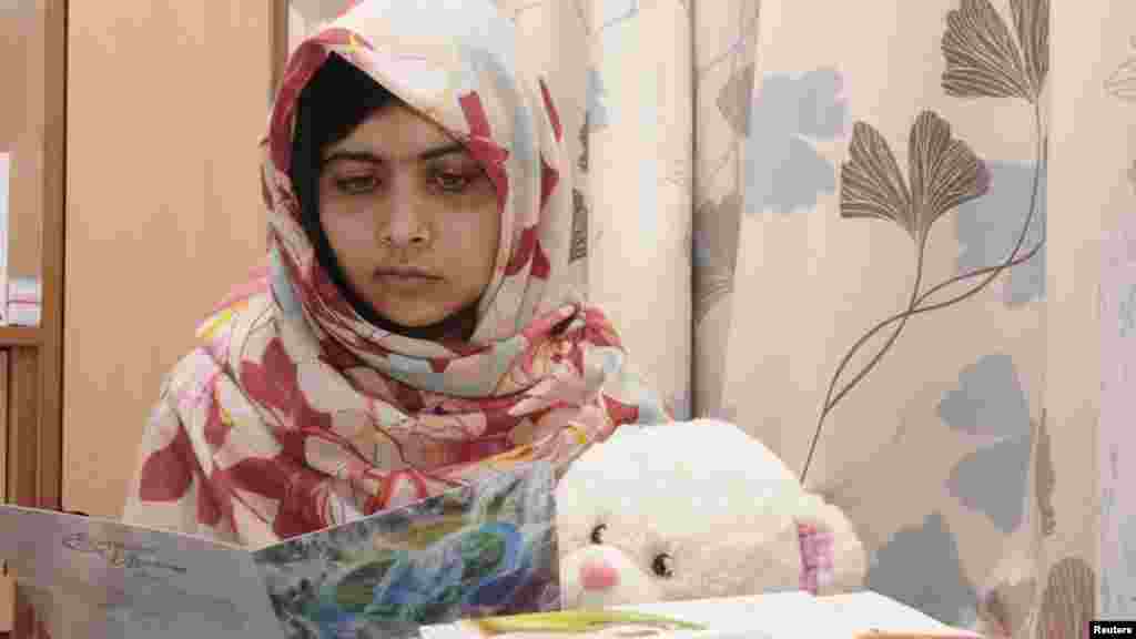 Pakistani schoolgirl Malala Yousafzai reads a get-well card as she recuperates at the the Queen Elizabeth Hospital in Birmingham, England. Malala, who was shot in the head by the Taliban for advocating girls&#39; education, was flown from Pakistan to Britain for specialist treatment after the October 9 attack. (Reuters)